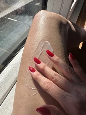 How to Get Smooth Legs by Giving Yourself a Leg Facial applying exfoliating creme to leg